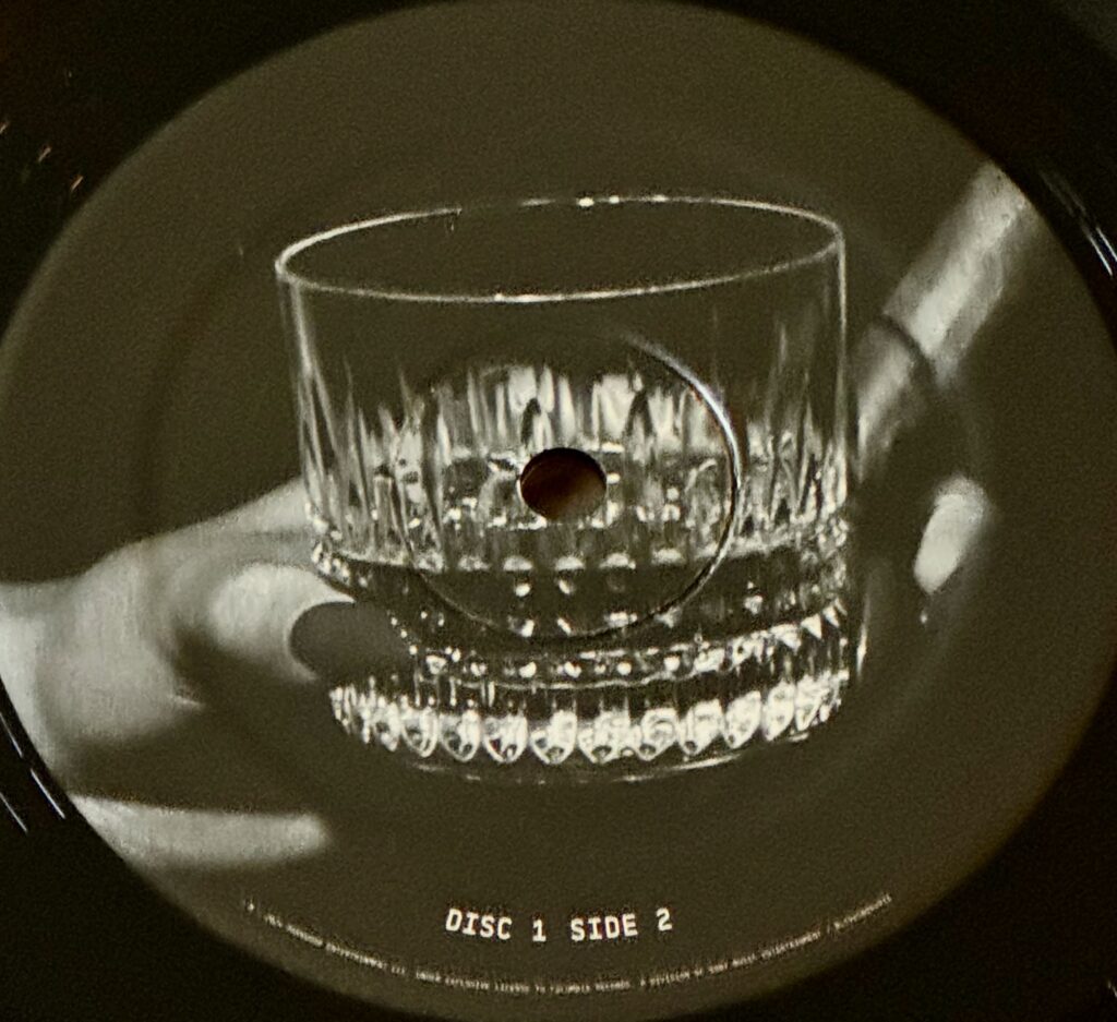 A rocks cocktail glass and cigar from disc 1 side 2 of Beyonce's Cowboy Carter