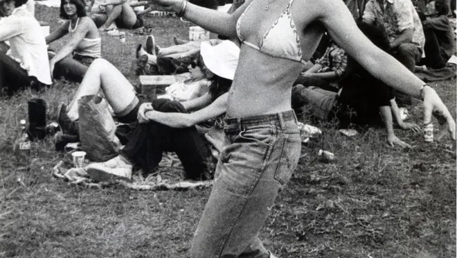 Hippie girl dancing at the picnic